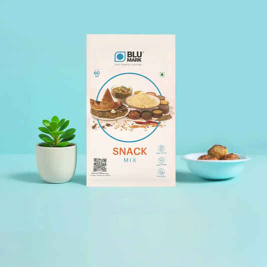Blu Mark snack mix packaging on a light blue background with a plant and bowl of snacks.